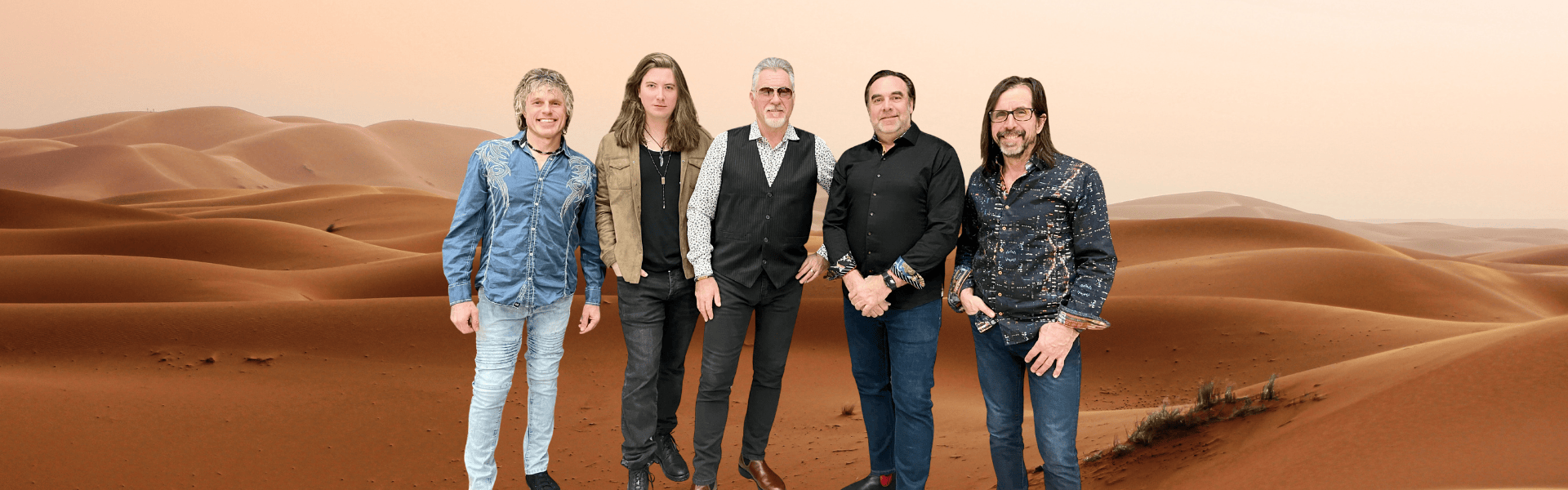 Image of five people standing in front of a desert background.